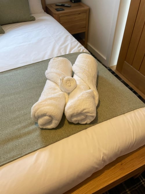 Decorative white towel animals on bed in Flotnar Hus room, Keiss Scotland