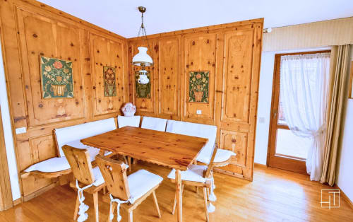 Wooden dining room with table and chairs, traditional Alpine decor, Cortina d'Ampezzo apartment