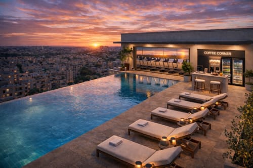 Rooftop infinity pool at DakarByDays hotel at sunset with lounge chairs and coffee corner overlooking Dakar skyline