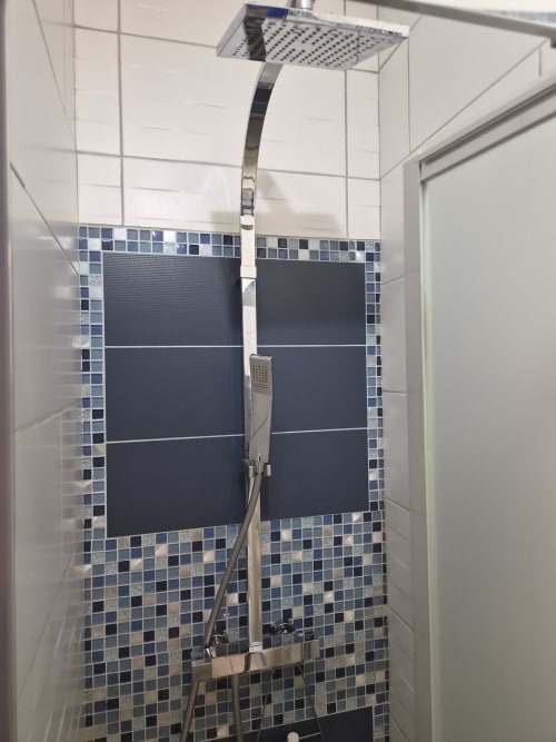 Salle de bains moderne à l'hôtel Orval Et Sens avec douche à effet pluie, carrelage mosaïque bleu et équipements élégants