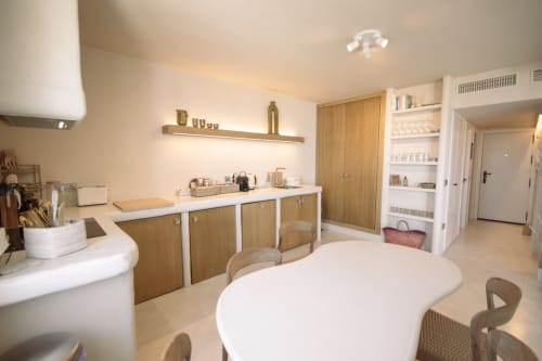 Modern hotel spa room at Escanda Building Solutions with white counters, wooden cabinetry, and relaxation seating