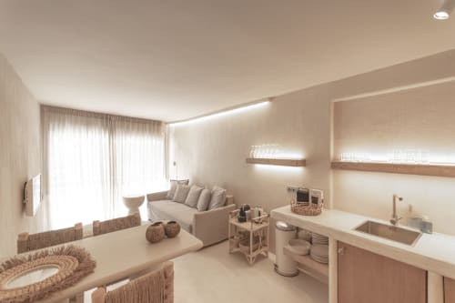 Modern hotel room at Escanda Building Solutions featuring combined living and kitchenette area with neutral tones and natural