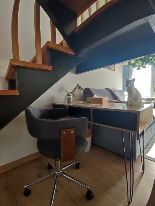 Espace de travail moderne dans un appartement d'Orvault avec bureau, chaise ergonomique et escalier