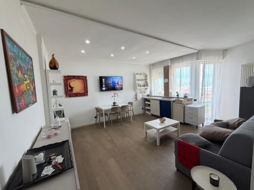 Modern luxury penthouse apartment at Versilia Panoramic with sea and mountain views, featuring living room, kitchen, dining