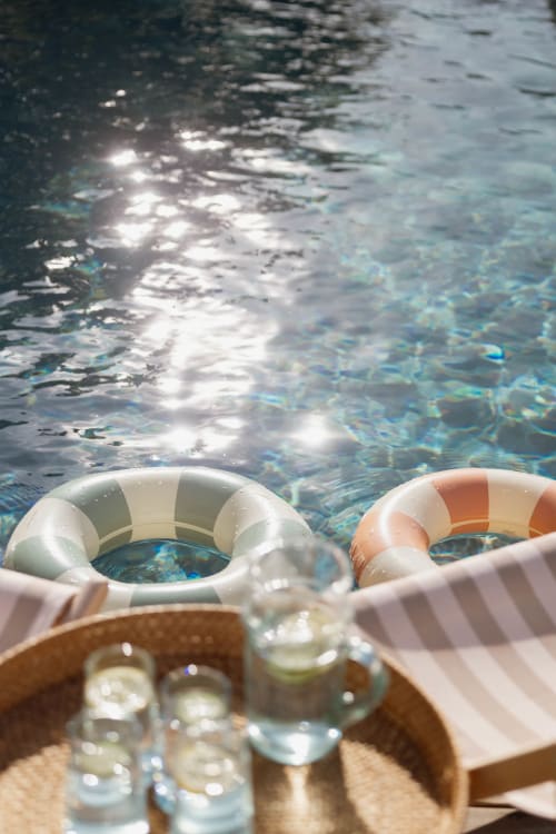 Bouées de piscine et boissons au bord de l'eau cristalline du Manoir de la Nogrie, Val d'Izé