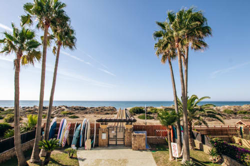 Beachfront surf shack with palm trees and ocean view at BH Marbella, Stromboli triplex apartment in Marbella, Spain