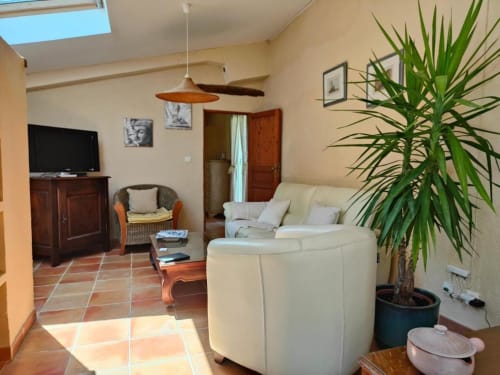 Spacieux séjour aux Gîtes Domaine Bellavigne, Forcalquier avec mobilier crème, carrelage terre cuite, lumière naturelle et