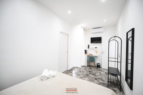 Camera Deluxe Newhouse Cavour a Bari con design minimalista moderno, letto, scrivania e specchiere con cornici nere