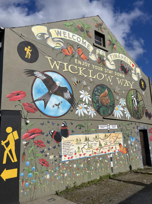Colorful mural welcoming visitors to Wicklow Way in Tinahely, Ireland, featuring nature and wildlife illustrations