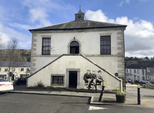 Historic whitewashed building with clock tower at Madelines Accommodation in Wicklow, Ireland