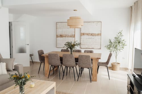 Modern dining area in mountain view apartment at Alojamientos Estrella Baeza with wooden table, gray chairs, and natural