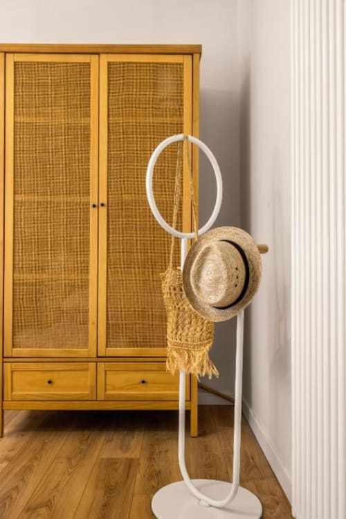 White coat stand with straw hat and woven bag in modern apartment at Dimora Silva Nature Suites