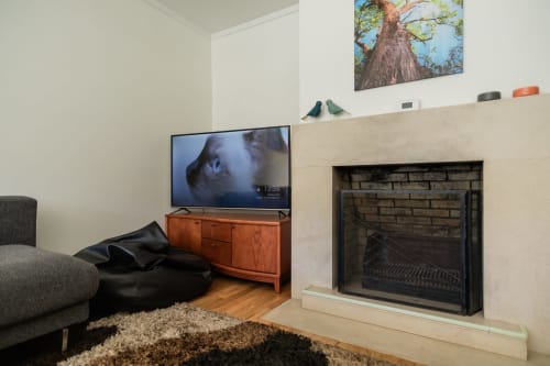 Modern living room at EcoHost Perafita with fireplace, TV on wooden stand, and comfortable seating