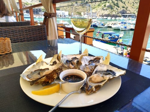 Huîtres fraîches et vin blanc à la Kimi Résidence, vue sur le port de Cannes et les bateaux amarrés