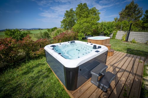 Hot tub on wooden deck at Cal Magí hotel in Guardiola de Font Rubi with countryside views