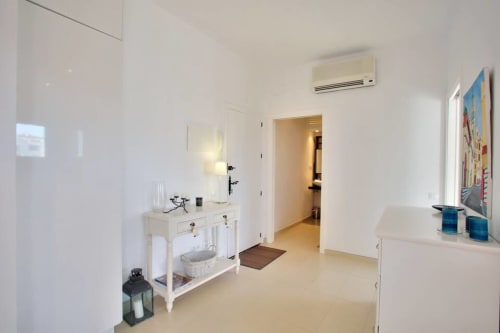 Modern bedroom in Marbella Home Rentals seaview apartment with white walls, minimalist decor, and contemporary furnishings in