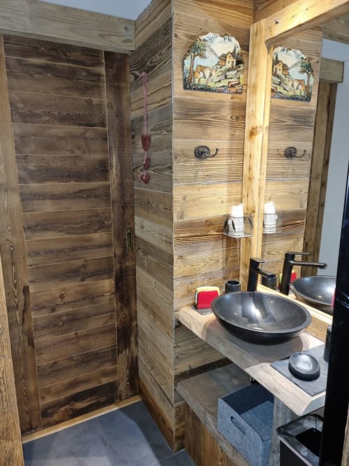 Salle de bains rustique à Zoppas Courchevel avec vasques doubles, miroirs et décoration alpine