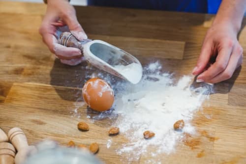 Hands rolling flour and nuts at Alessia's Place B&B in Como, Italy - artisan cooking experience