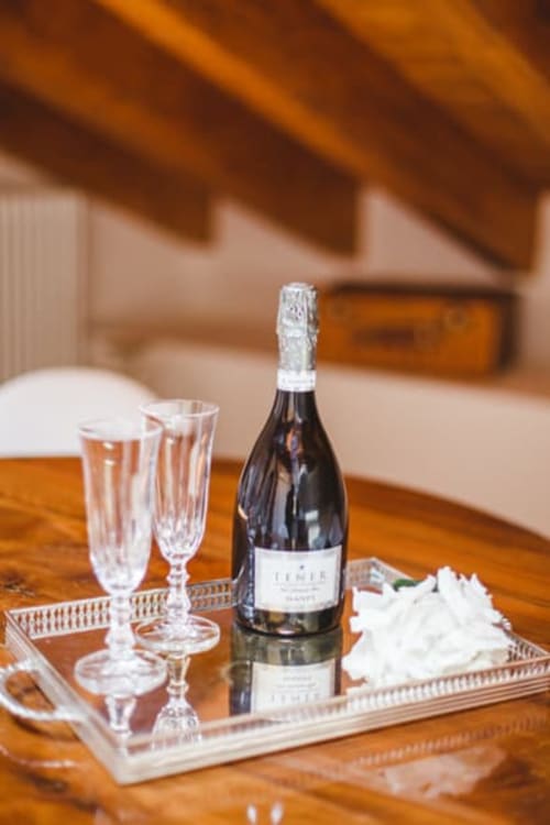 Champagne bottle with flutes on wooden tray at Alessia's Place boutique hotel in Como