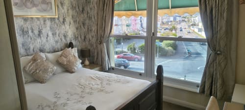 Cozy double bedroom at The Sands Hotel, Paignton with sea view, elegant furnishings and street-level windows