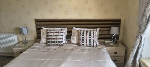 Deluxe double bed with decorative pillows at The Sands Hotel in Paignton, GB