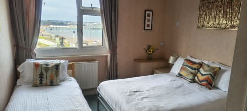 Triple room at The Sands Hotel in Paignton with twin beds, sea view windows, modern amenities and coastal scenery