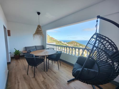 Romantic balcony apartment at Nido Anaga with hanging chair, dining table, sea views overlooking Tenerife coastline