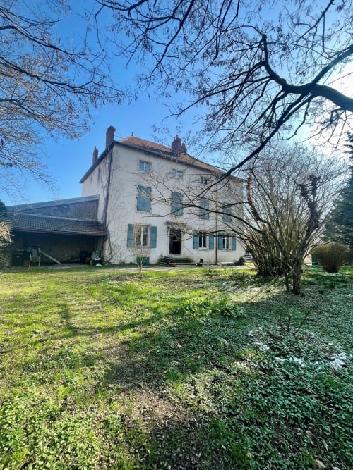 Élégante demeure historique blanche de la Maison Agami B&B à Rosières aux Salines, avec arbres nus et jardins soignés