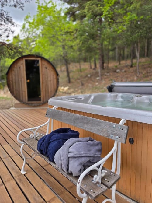 Barrel sauna and hot tub with towels on wooden deck at Destination Ailleurs, Castellane