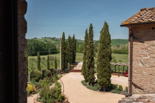 Tuscan countryside view from Agriturismo La Frattina, Siena - cypress trees, rolling hills, terracotta roof