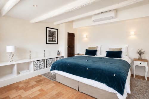 Spacious Suite Sainte Victoire bedroom at Les Suites de Montigny in Aix-en-Provence with king bed, white built-in storage,