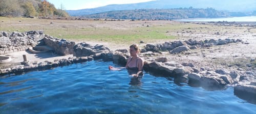 Mujer disfrutando de la piscina de aguas termales naturales en Aldea Rural Santo André en Ourense, España