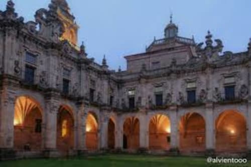 Monasterio de piedra histórico en la aldea rural Santo André, Ourense España, iluminado al atardecer con columnata de arcos