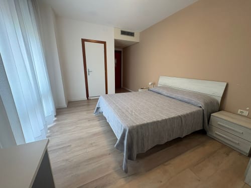 Spacious family bedroom at Hotel Panorama Lido di Jesolo with double bed, modern furnishings, and air conditioning