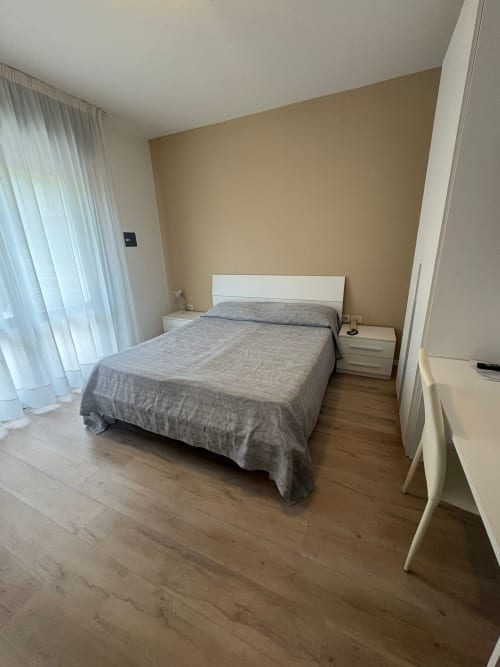 Hotel Panorama family room in Lido di Jesolo with double bed, white headboard, and modern furnishings