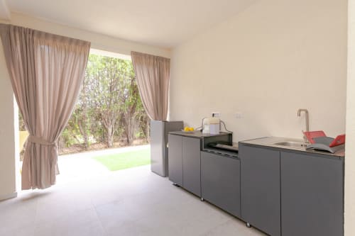 Modern kitchenette with garden view at Le Dune Relax hotel in San Teodoro, Italy