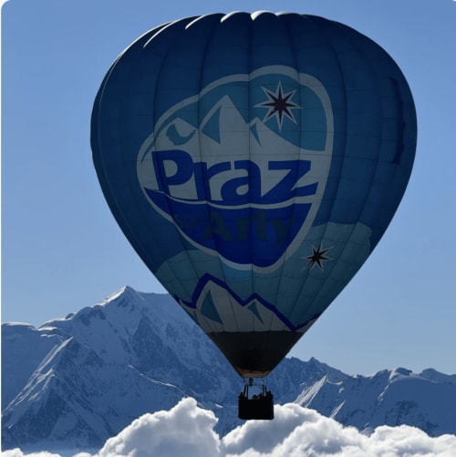 Praz hot air balloon floating above snowy Alps near Chez Francine, Notre Dame de Bellecombe