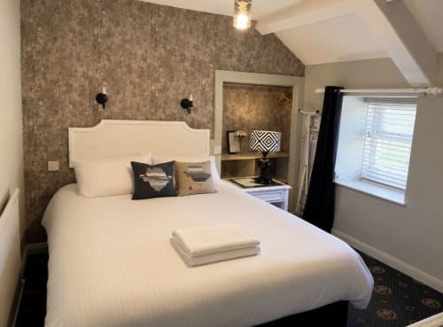 Cozy Standard Double Room at Gwesty Holland Hotel in Holyhead with white bedding, textured wallpaper, and modern amenities
