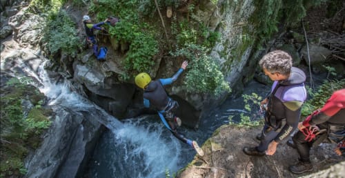 Canyoning adventure near Chez Francine in Flumet, France with participants navigating rocky water streams