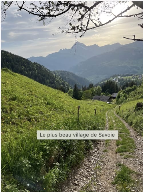 Alpine meadow path overlooking Flumet valley with mountains, Savoie