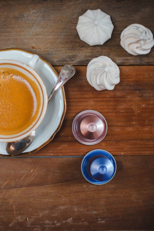 Dessert preparation at Alessia's Place Como: meringue cookies, pumpkin mousse, and spice ingredients on wood table.