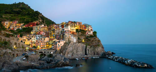 Pittoresco borgo arroccato sulle scogliere con edifici colorati affacciati sul mare azzurro di Cinque Terre, Italia