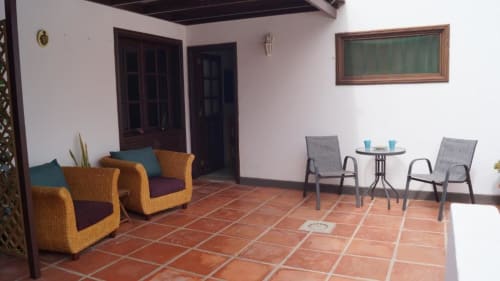 Terrace at Villa Estrella Polar with wicker armchairs, dining table, and mountain views in Tahiche