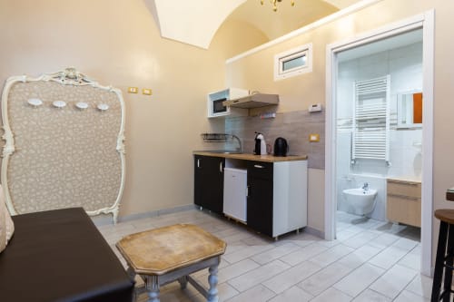 Casa Scola Loano bedroom with kitchenette, bathroom, and elegant furnishings in Loano, Italy
