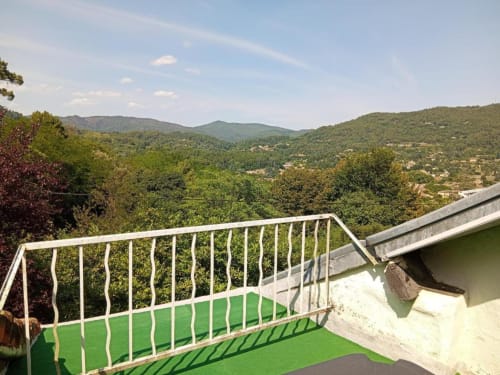 Terrace with white railing overlooking lush green mountains and valleys near St Jean Du Gard, Domaine de Cabrières