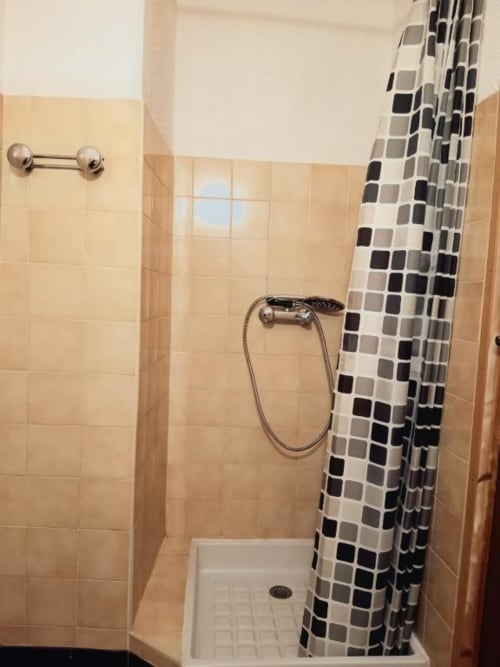 Modern shower stall with black and white checkered curtain at Domaine de Cabrières, St Jean Du Gard, France.
