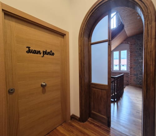 Juan Pinto apartment entrance at Fabrica de Atardeceres with wooden doors and archway to balcony