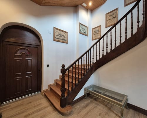 Elegant staircase with dark wood railing in Fabrica de Atardeceres apartment 3-Juan Pinto, Spain