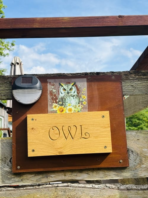 Owl Country Cabin sign with owl and sunflower artwork at Postwood Gardens Campsite in Kentisbeare