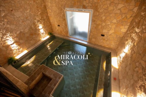 Terrazza Miracoli & Spa pool area at Neapolis Tecnotourist BnB with cork walls and skylight window in Italy